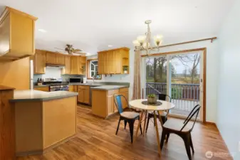 Dining room with easy access to large back deck and open kitchen with
