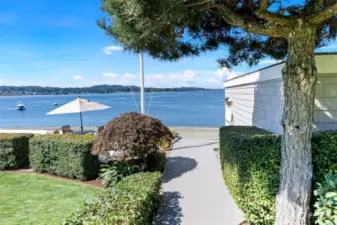 Path leading to beach with boathouse on the right