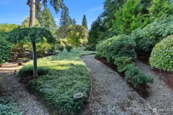 Upper portion of property has walkways between the well manicured landscape