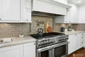 Professional-grade gas range and designer tile backsplash offer form and function in this Sammamish waterfront kitchen.