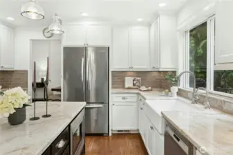 Granite countertops, classic subway tile, high ceilings, pendant lighting and a farmhouse sink with peaceful views of your private lakeside backyard.
