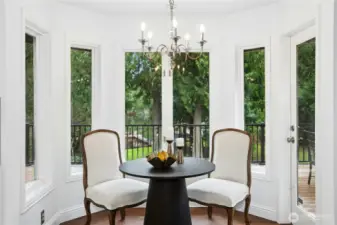 Charming breakfast nook wrapped in windows- enjoy your morning coffee overlooking lush greenery and Beaver Lake.