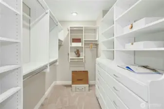 Thoughtfully designed walk-in closet with abundant hanging space, custom shelving, and built-in drawers to keep everything organized and within easy reach.