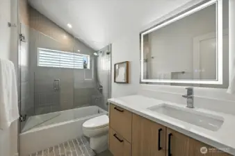 2nd bath with tile tub surround and vaulted ceilings
