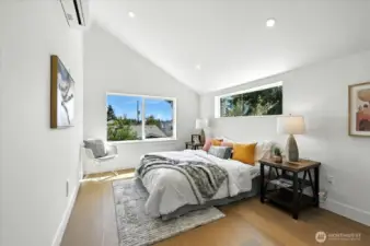 Primary Suite with hardwoods and vaulted ceilings