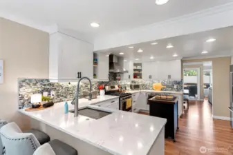 Kitchen remodel expanded the space and created new counter seating and this ideal gathering place. Gas range is an added bonus as the gas utility is included in the HOA!