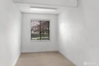 This 4th room on the lower level could be used as a bedroom as it has a window for egress and sufficient dimensions and square feet. Currently it is used as a workshop and tool room. IMAGE HAS BEEN VIRTUALLY UNSTAGED TO REMOVE ITEMS IN ROOM.