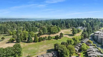 The condo community sit adjacent to the golf course and is surrounded by evergreen trees and vast open space.