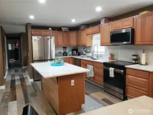 Very Spacious Island Kitchen with New Granite Counter Tops, Sink, Faucet, Stainless Appliances, Real Solid Oak Cabinets, LED Lighting, Paint,Trim, and Vinyl Plan Flooring.