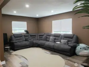 view of the Huge Entertaining Living Room Showing Fresh Paint, Trim and Vinyl Plank Flooring.