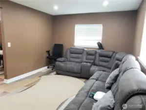 A Different view of the Huge Entertaining Living Room Showing Fresh Paint, Trim and Vinyl Plank Flooring.