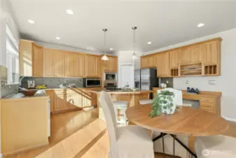 Chef's kitchen with ample cabinet and built in desk