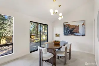 The spacious dining room features vaulted ceilings and a new statement chandelier.