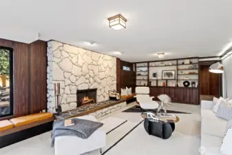 The lower level features an expansive rec room with mid-century style rock fireplace banked by custom benches with custom cushions.