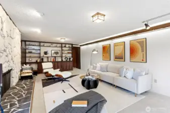 The lower level features an expansive rec room with mid-century style rock fireplace banked by custom benches with custom cushions.