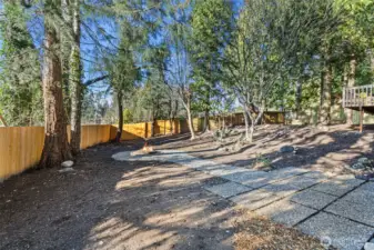 The private backyard boasts a brand new fence on the south side of the lot, mature trees with paths and plenty of room to roam.