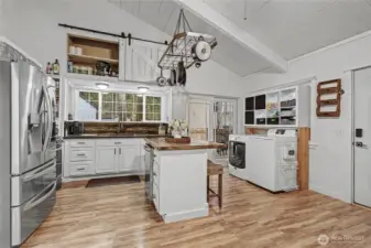 View of your kitchen from the living room, beautiful flooring and your front door is to your right. Look at those ceilings! Feels spacious inside.