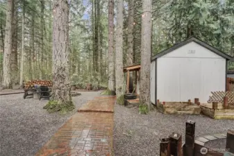 Pathway from your deck to your additional storage shed, currently used as a guest bedroom.