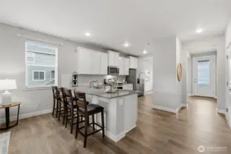 large counter with breakfast bar, perfect for eating and entertaining