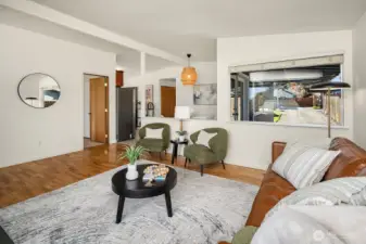 The family room is through the door to the right of the mirror.