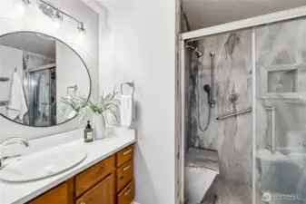 Another view of the upgraded bathroom with quartz counter tops and new fixtures.