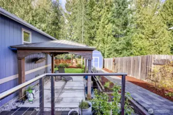 Beyond the gate is a beautifully landscaped backyard.