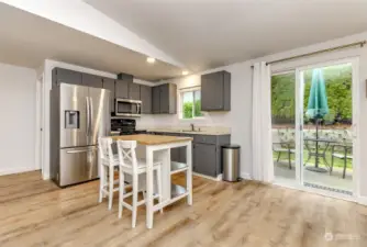 The kitchen has a portable island.  There is a pantry on the left side.