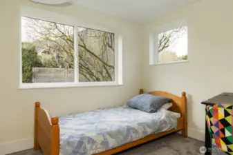 Bright 4th bedroom with radiant ceiling heat and custom closet.