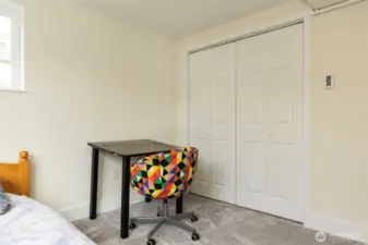 Bright 4th bedroom with radiant ceiling heat and custom closet.