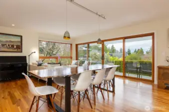 Light-drenched living/dining area with views from the windows and  attached balcony.