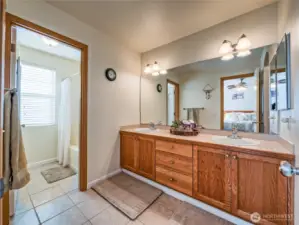 Primary bathroom with tile counters & floors