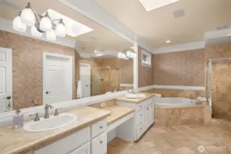 Sky-lit 5-piece en-suite bath with jetted corner soaking tub.