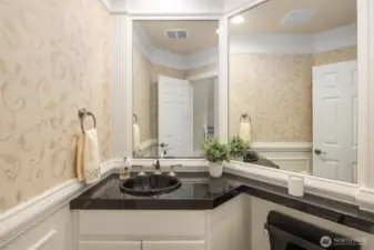 Main floor powder room with granite countertops.