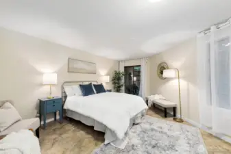 The primary suite has ample room for a king size bed. It offers sliders to a quiet patio, walk-in closet and full bath.