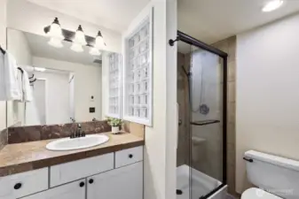 Guest bath with tile stall shower and good storage. The laundry is adjacent to this bath, stacked washer and dryer plus a laundry tub.