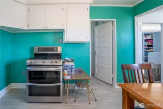 Other side of kitchen area.  Door that goes into the full bath.  Doorway to the right goes to the utility room/laundry and the entry from the side porch.
