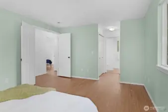 Primary bedroom facing hallway to ensuite + closets