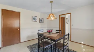 Enjoy meals in this classic dining room with charming light fixture and a cozy atmosphere.