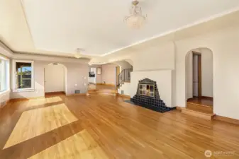 Flowing hardwood floors in the main living area with plenty of natural light