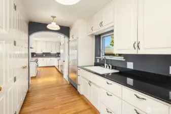 The Butlers pantry offers additional fridge space, tons of storage and a dish prep.