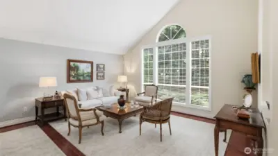 The living room is light and open with the soaring vaulted ceiling.