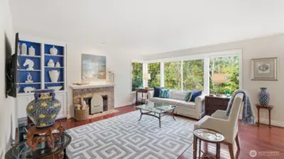 A brick surround gas log fireplace sets the warm feeling while enjoying the gorgeous private views.  There are built-in shelves and cabinets.