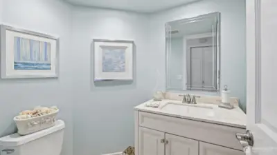 The powder room is updated with quartz counter and undermount sink.