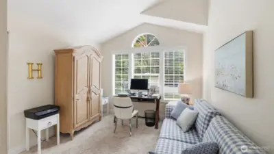 One bedroom has a peaked ceiling and a walk-in closet and custom paint.