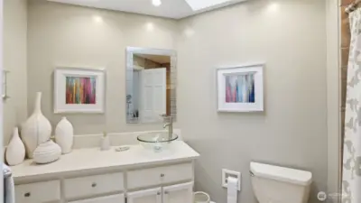 The upstairs full hall bath has been updated with quartz counters, tile floors plus skylight.