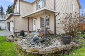 Gorgeous water feature in the front of the home.  Enjoy your cup of coffee on the covered front porch while listening to the soothing sound of running water.
