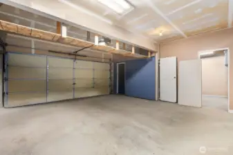 3 bay garage has 3rd bay divided into a storage room and a workshop.