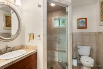 Primary bath with custom tile and a walk-in shower.