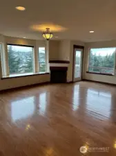The living room has a gas fireplace and faces west for the city and bay views