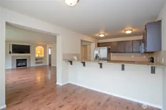 The dining area flows seamlessly into the family room, offering a connected and flexible layout. A convenient eating bar is perfect for quick bites or chatting with guests while cooking.